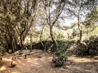 a park with a bench in the middle of a forest at Tente Lodge avec Terrasse - 5 Pers, 2 Ch, Réfrigérateur - API-1-52-1658 in Sartène