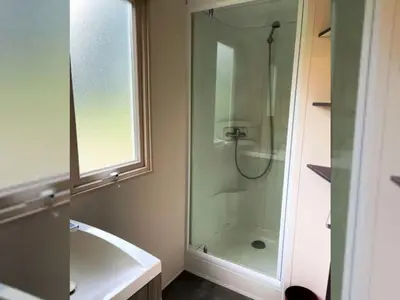 a bathroom with a shower and a sink and a tub at Mobil Home 3 Chambres avec Terrasse - Pour 6 Personnes - API-1-52-1659 in Sartène