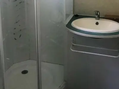 a small bathroom with a sink and a toilet at Bungalow Confort 5 Pers avec Terrasse - API-1-52-1660 in Sartène