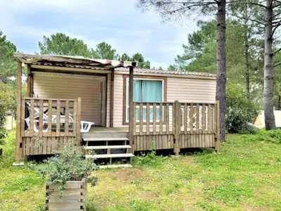 a tiny house with a porch and a deck at Mobil-home confortable avec terrasse pour 4 pers. - API-1-52-1661 in Sartène