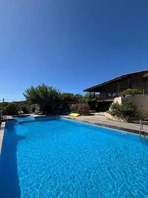 a large swimming pool with blue water at VILLA Cala D'orzu in Coti-Chiavari