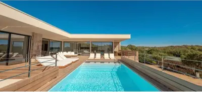 a house with a swimming pool on a balcony at Villa CASATANGO in Zonza