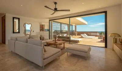 a living room with a flat screen tv on the wall at Villa CASATANGO in Zonza