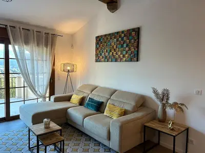 a living room with a large couch in a room at Charmante villa dans un petit coin de Paradis in Propriano