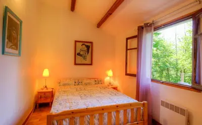 a bedroom with a bed and two windows at Casa Lisandru