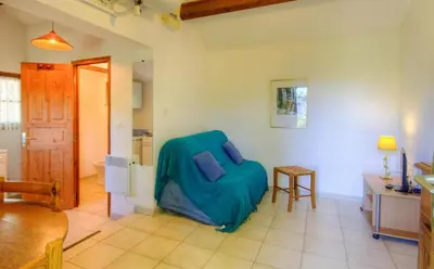 a living room with a blue couch and a table at Casa Lisandru