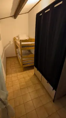 a television in a room with a tiled floor at Casa Lisandru