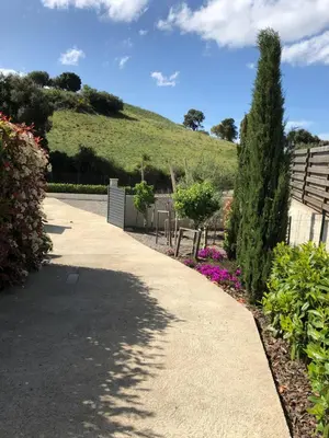 a walkway in a garden with a hill in the background at A Murella - maison de vacances à Oletta en Corse in Oletta