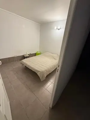 a bedroom with a bed and a tiled floor at u limone in Porticcio