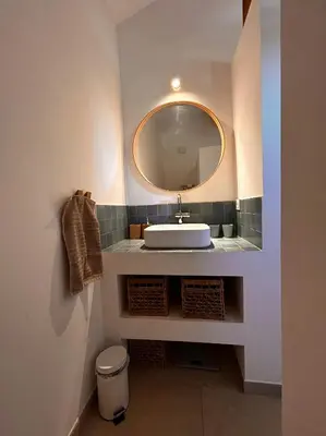 a bathroom with a sink and a mirror at Granite Villa Between Porto-Vecchio And Bonifacio in Figari