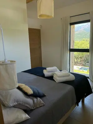 two beds sitting in a room with a window at Granite Villa Between Porto-Vecchio And Bonifacio in Figari