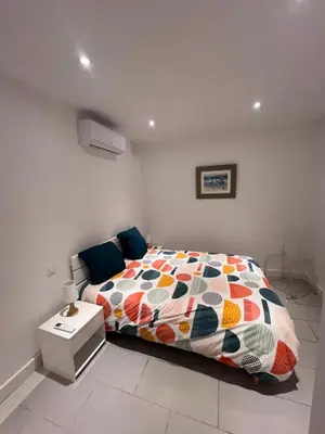 a bedroom with a bed with a colorful comforter at Le magasin in Conca