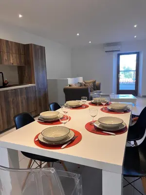 a table with plates and wine glasses on it at Le magasin in Conca