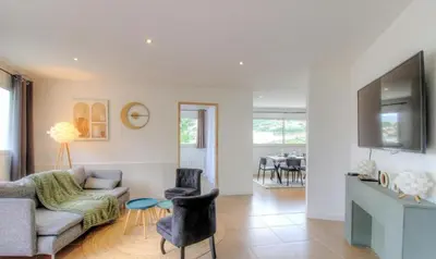 a living room with a couch and a table at Appartement avec grande terrasse in Viggianello