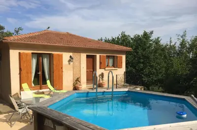 a swimming pool in front of a house at Maison avec piscine sans voisinage à 4km de la mer in Canale-di-Verde