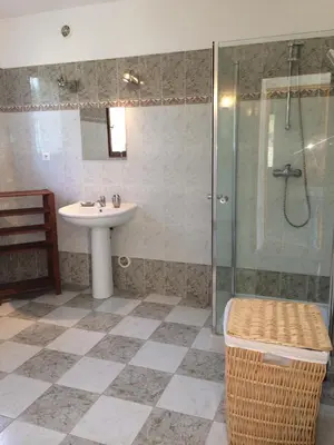 a bathroom with a sink and a shower at Maison avec piscine sans voisinage à 4km de la mer in Canale-di-Verde