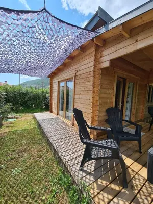 two chairs sitting on the porch of a house at Casa Di Legnu -T2 - Calme et bien situé in Appietto