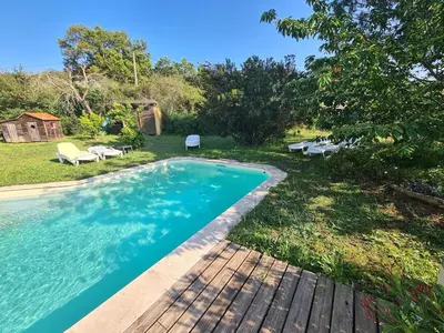 a swimming pool in the backyard of a house at Casa Di Legnu -T2 - Calme et bien situé in Appietto