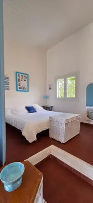 a bedroom with a large bed and a table at Maison vue mer Porticcio in Porticcio
