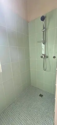 a bathroom with a shower with a tiled floor at Maison vue mer Porticcio in Porticcio