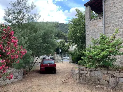 a red car parked next to a building at Sartene - Corse du sud ouest in Sartène