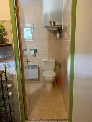 a small bathroom with a toilet and a window at Sartene - Corse du sud ouest in Sartène