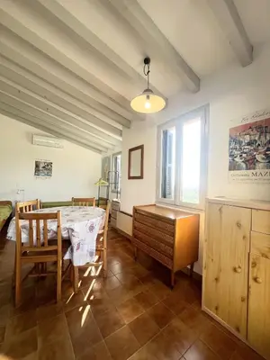 a dining room with a table and a desk at Appartement au cœur de Porticcio in Porticcio