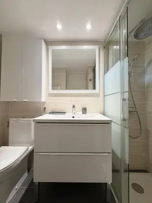 a white bathroom with a sink and a shower at Charmant studio au centre de Porticcio in Grosseto-Prugna