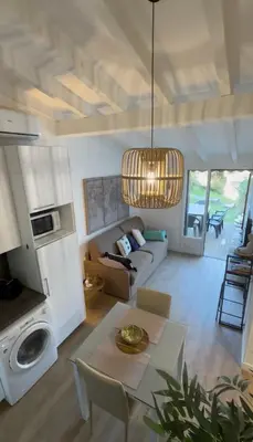 a living room with a couch and a table at Charmant studio au centre de Porticcio in Grosseto-Prugna