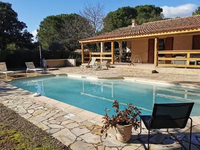 a swimming pool in front of a house at Charmante Villa Privée avec Piscine in Porto-Vecchio