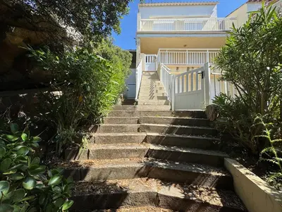 a set of stairs leading up to a house at Mini villa Stagnola in Pietrosella