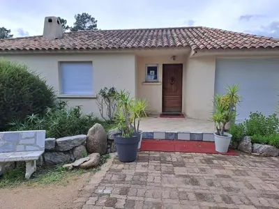 a house with a bench in front of it at Villa Mare E Muntagna in Porto-Vecchio