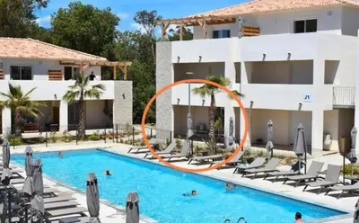 a pool at a hotel with an orange water slide at Petit havre de paix au bord de la mer in Linguizzetta