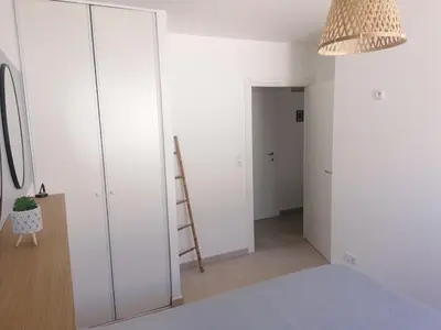 a bedroom with white walls and a ladder at Petit havre de paix au bord de la mer in Linguizzetta