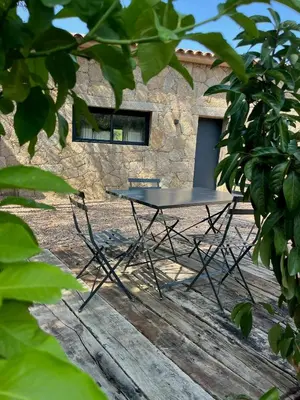 a table and chairs in front of a building at Stone House Between Porto-Vecchio And Bonifacio in Figari