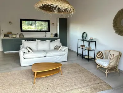 a living room with a white couch and a table at Stone House Between Porto-Vecchio And Bonifacio in Figari