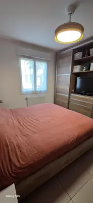 a bedroom with a large bed and a television at T3 Cosy Ajaccio in Ajaccio