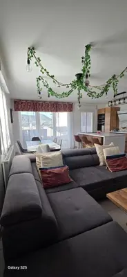 a living room with a large couch with pillows at T3 Cosy Ajaccio in Ajaccio