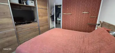 a bedroom with a bed and a flat screen tv at T3 Cosy Ajaccio in Ajaccio