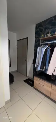 a room with a closet with clothes and a door at T3 Cosy Ajaccio in Ajaccio