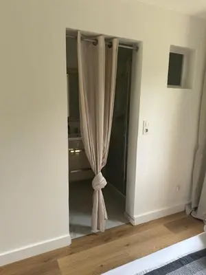 a room with a window with a curtain in it at Studio climatisé avec terrasse privative in Corte