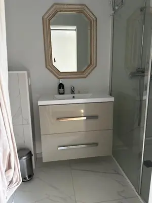 a bathroom with a sink and a mirror at Studio climatisé avec terrasse privative in Corte