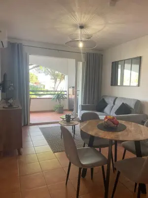 a living room with a couch and a table at Entre mer et montagne in San-Nicolao