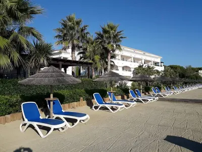 a row of chairs and umbrellas on a beach at Entre mer et montagne in San-Nicolao