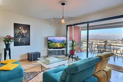 a living room with a couch and a tv at Casa Simona - View of the Gulf of Ajaccio in Ajaccio
