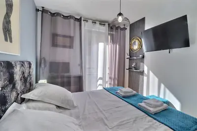 a bedroom with a bed with two towels on it at Casa Simona - View of the Gulf of Ajaccio in Ajaccio