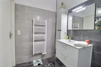 a bathroom with a white sink and a mirror at Casa Simona - View of the Gulf of Ajaccio in Ajaccio