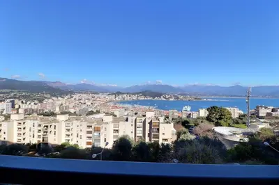 a view of a city with buildings and a body of water at Casa Simona - View of the Gulf of Ajaccio in Ajaccio