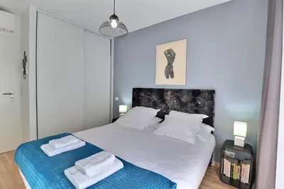 a bedroom with a large bed with two towels on it at Casa Simona - View of the Gulf of Ajaccio in Ajaccio