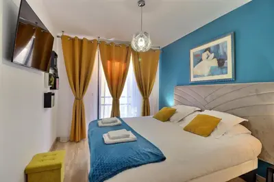 a bedroom with a large bed with a blue wall at Casa Simona - View of the Gulf of Ajaccio in Ajaccio